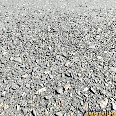 Worn asphalt with faded fragments of painted road lines