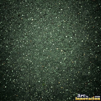 Asphalt pavement marked with oil stains and tire scuffs in medium gray
