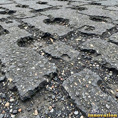 Worn asphalt with faded fragments of painted road lines