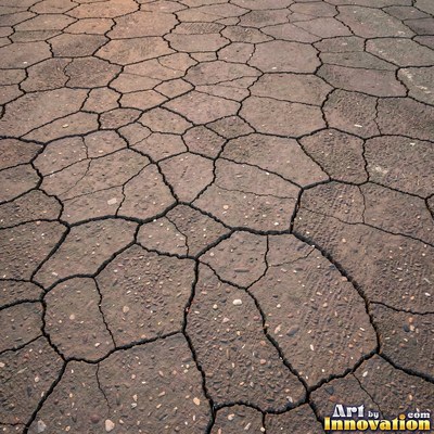 Asphalt pavement marked with oil stains and tire scuffs in medium gray