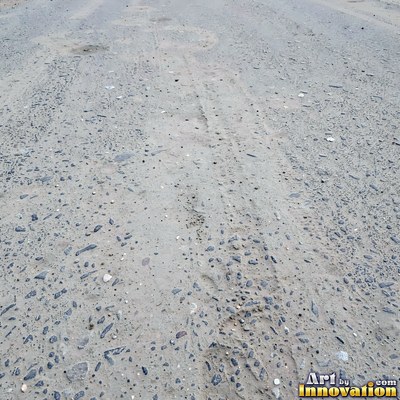 Worn asphalt with faded fragments of painted road lines
