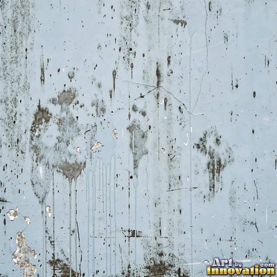 Blackened grunge wall with dried paint splatter filling the frame