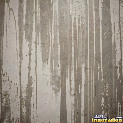 Blackened grunge wall with dried paint splatter filling the frame