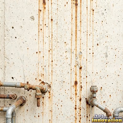 Blackened grunge wall with dried paint splatter filling the frame