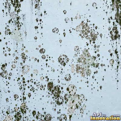 Blackened grunge wall with dried paint splatter filling the frame