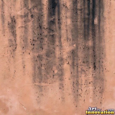 Grungy beige wall splattered with old paint drips, shot flat and even