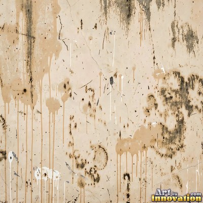 Grungy beige wall splattered with old paint drips, shot flat and even