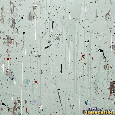 Grungy beige wall splattered with old paint drips, shot flat and even