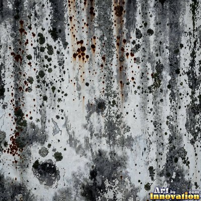 Grungy beige wall splattered with old paint drips, shot flat and even
