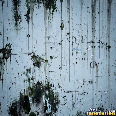 Old blue gray wall built up in layers of patched plaster and paint