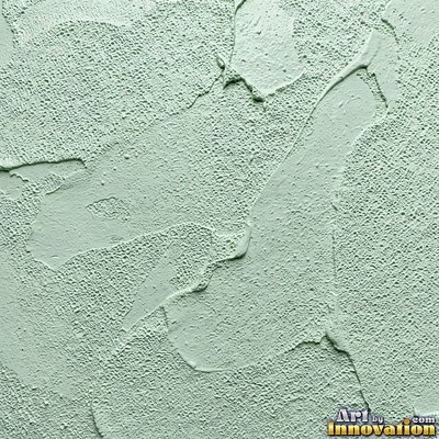 Cracked plaster with fine spidery lines in faded mint green paint