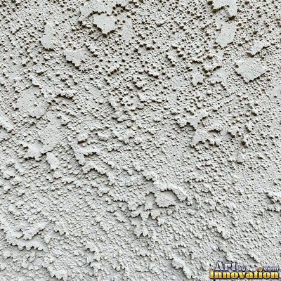 Rough sand textured stucco in warm beige under even front light