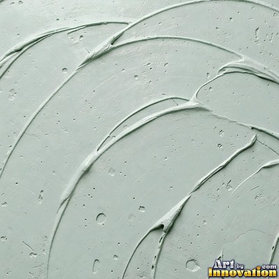 Cracked plaster with fine spidery lines in faded mint green paint