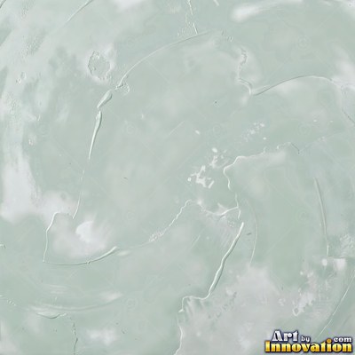 Cracked plaster with fine spidery lines in faded mint green paint