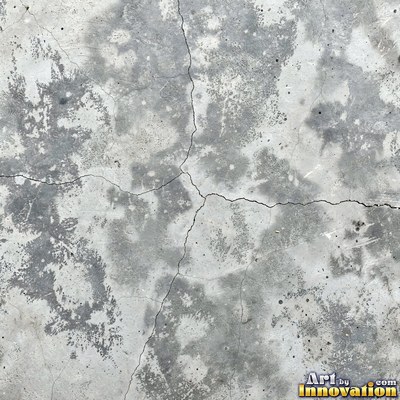 Smooth raw concrete with small air holes scattered across the surface
