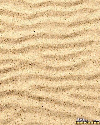 Pale golden wet sand with a shiny surface and tiny pits