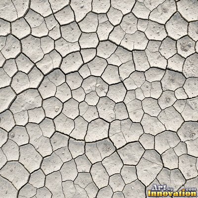 Dry cracked sand crust in rust red clay tones