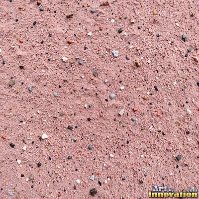 Pale golden wet sand with a shiny surface and tiny pits