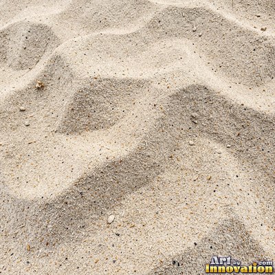 Pink sand marked with small swirls carved by the wind