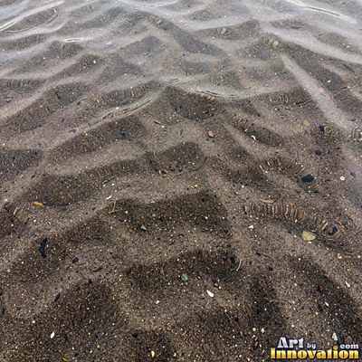 White coral sand dune surface with soft shadowed ridges