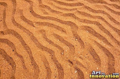 Dry cracked sand crust in rust red clay tones