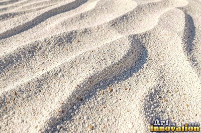 White coral sand dune surface with soft shadowed ridges