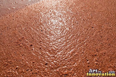 Pink sand marked with small swirls carved by the wind