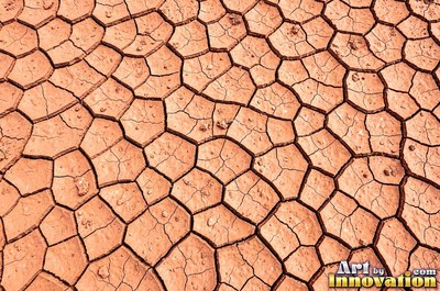 Wet rust red mud with shiny pools and soft ridges