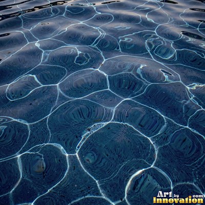 Choppy water surface of many small waves with gold reflections