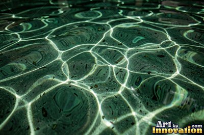 Rain drops hitting a water surface in crystal clear tones