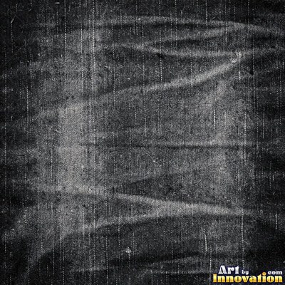 Faded black denim with whiskered fading across the weave