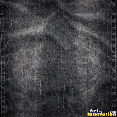Faded black denim with whiskered fading across the weave