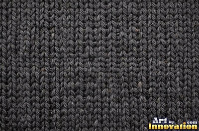Chunky garter stitch in thick black wool, a full frame knit texture