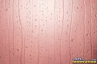 Hammered glass covered in small dimples with a rose pink tint