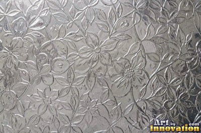 Hammered glass covered in small dimples with a rose pink tint