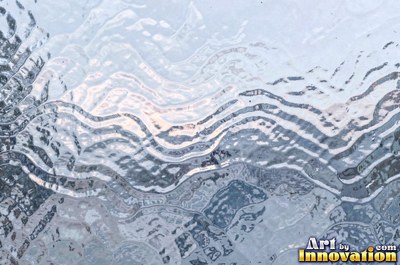 Rippled glass bending the light into soft waves of icy blue