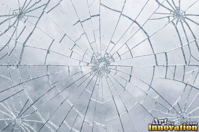 Cracked glass with light catching the fracture edges