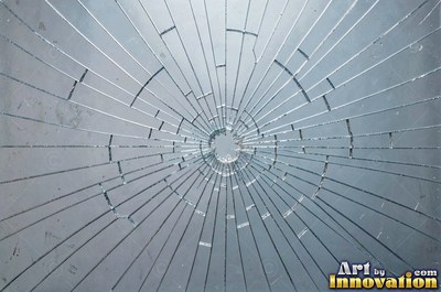 Cracked glass with light catching the fracture edges