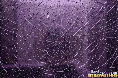 Laminated glass with a web of cracks held together, faint blue tint