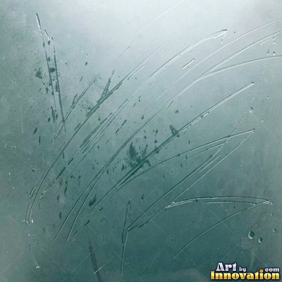 Frosted glass with soft emerald bokeh lights behind it