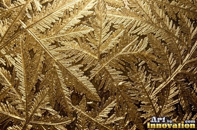 Cracked lake ice with white fracture lines and a honey gold glow