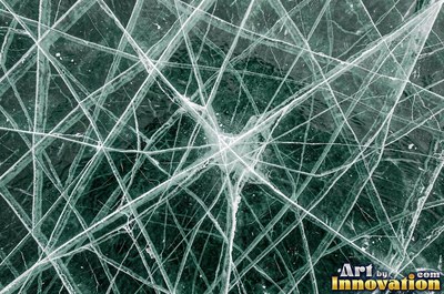 Snowflakes resting on dark sea green ice