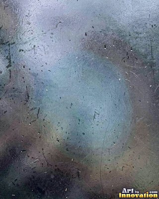 Iridescent glass shards scattered edge to edge in teal