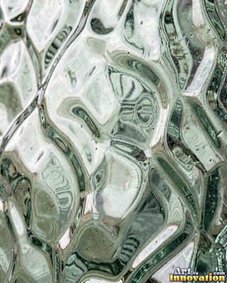 Iridescent glass shards scattered edge to edge in teal