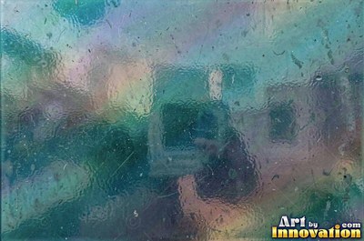 Iridescent glass shards scattered edge to edge in teal