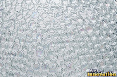 Iridescent glass bubbles packed together in icy blue