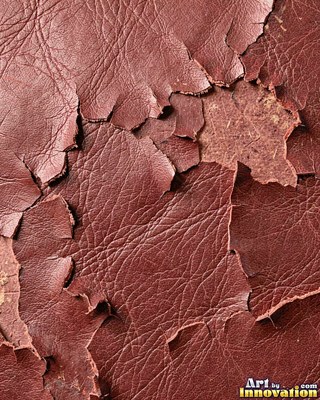 Burgundy leather marked with water stains and dark spots