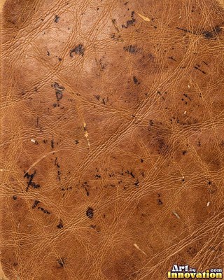 Worn saddle tan leather scuffed pale along the creases
