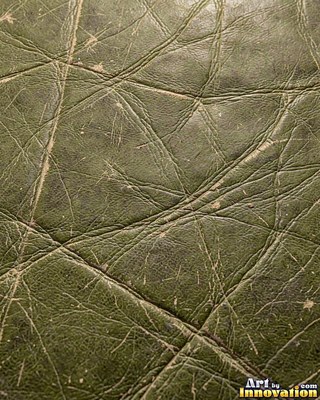 Old cracked leather with a crazed surface in whiskey brown