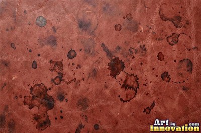 Burgundy leather marked with water stains and dark spots